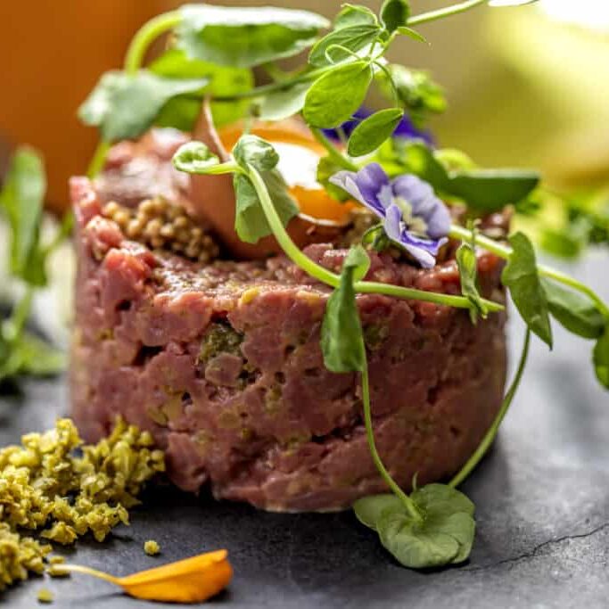 Beef steak tartare with raw egg yolk. French cuisine
