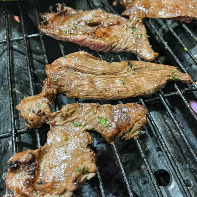 carne-asada-beef-flank-being-grilled-with-corn-co-2022-11-10-02-52-15-utc